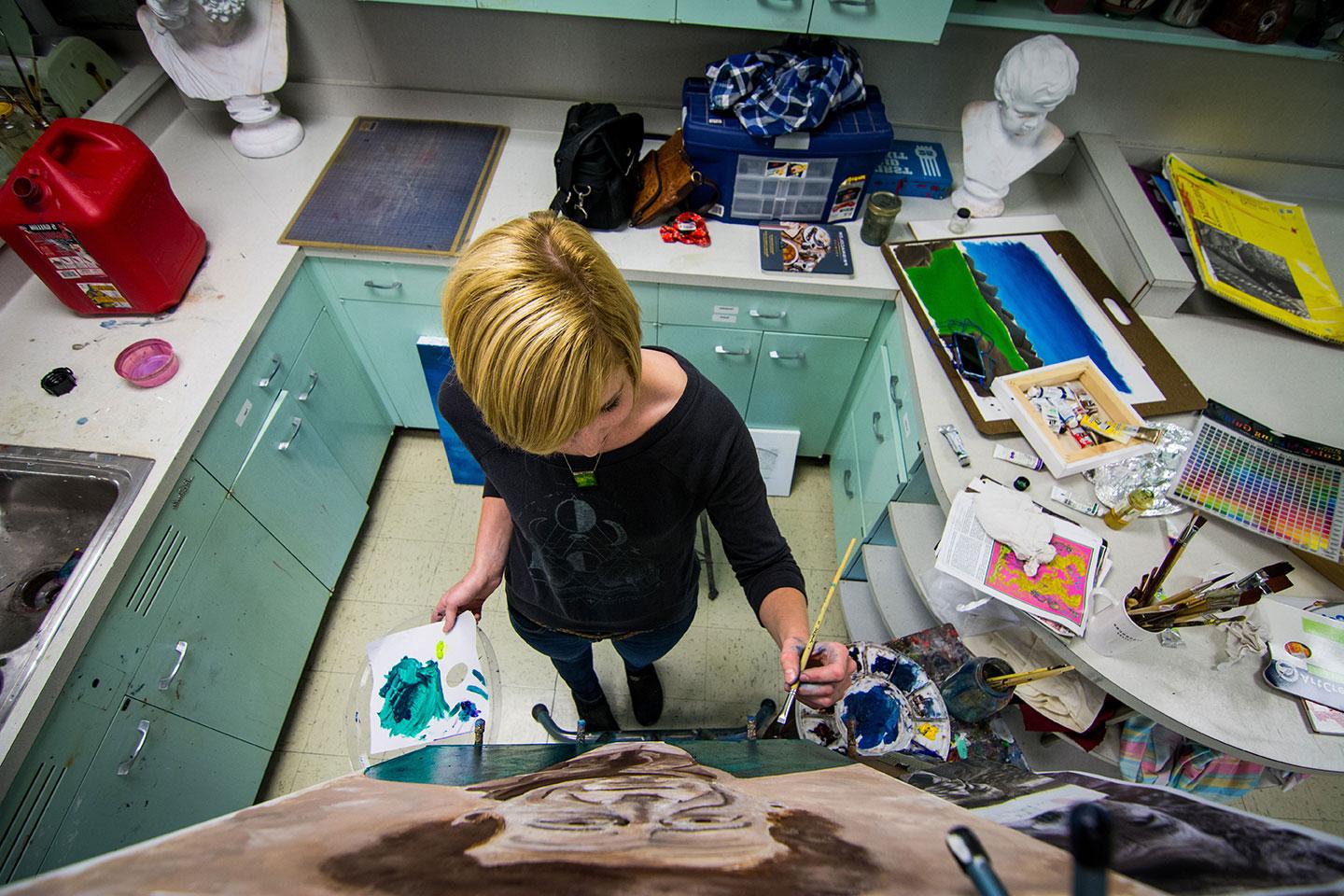 Student working on a painting